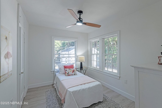 bedroom with ceiling fan and light hardwood / wood-style flooring