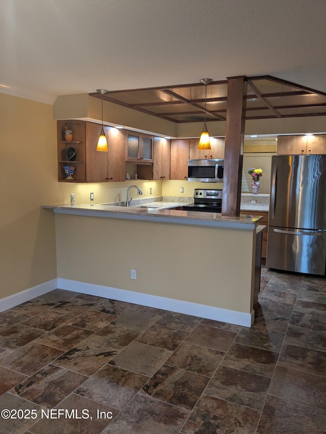 kitchen featuring kitchen peninsula, sink, stainless steel appliances, and pendant lighting