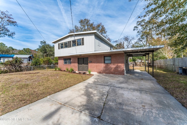 view of front facade with a front lawn and a carport