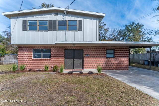 view of front facade with a carport and a front yard