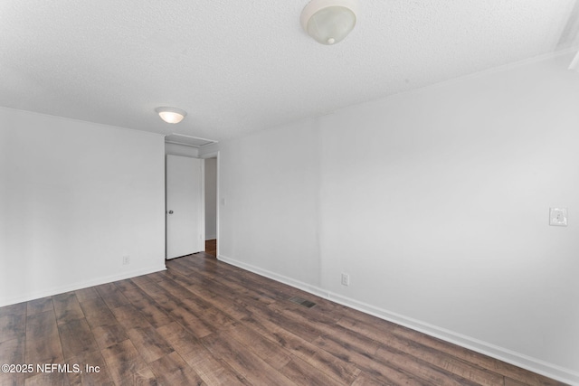 unfurnished room featuring a textured ceiling and dark hardwood / wood-style floors