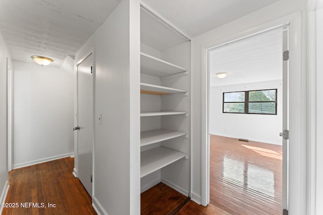 interior space featuring dark hardwood / wood-style flooring and a textured ceiling