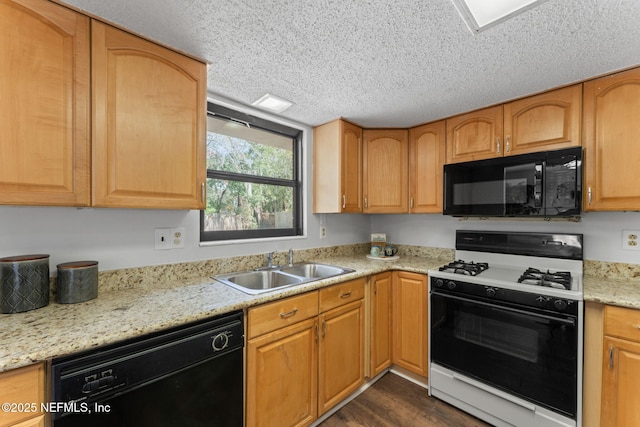 kitchen featuring dark wood-type flooring, a textured ceiling, black appliances, light stone counters, and sink