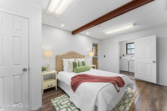 bedroom with a textured ceiling, washer and clothes dryer, dark hardwood / wood-style flooring, and beamed ceiling