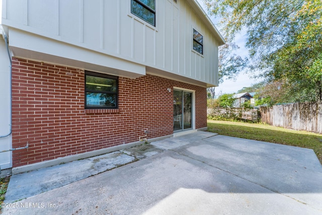 rear view of house with a patio area and a yard