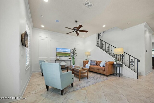 tiled living room with crown molding and ceiling fan