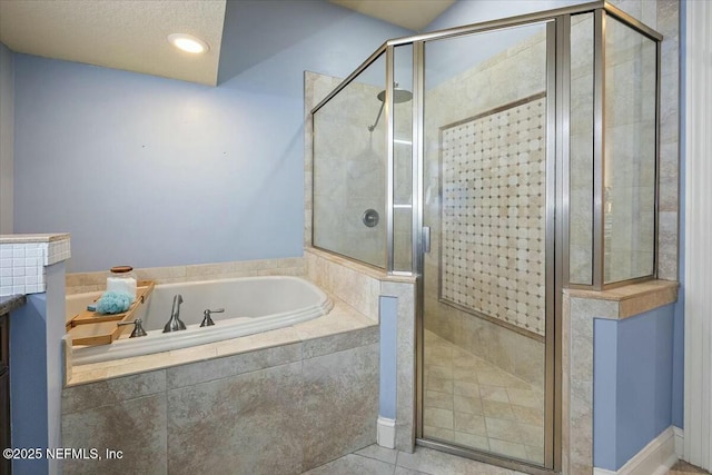 bathroom with separate shower and tub and tile patterned floors