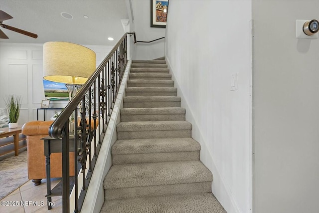 stairway with tile patterned floors and ceiling fan