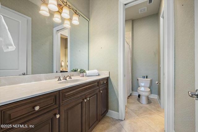 bathroom featuring vanity, tile patterned floors, and toilet