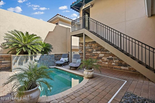 view of swimming pool featuring a patio area