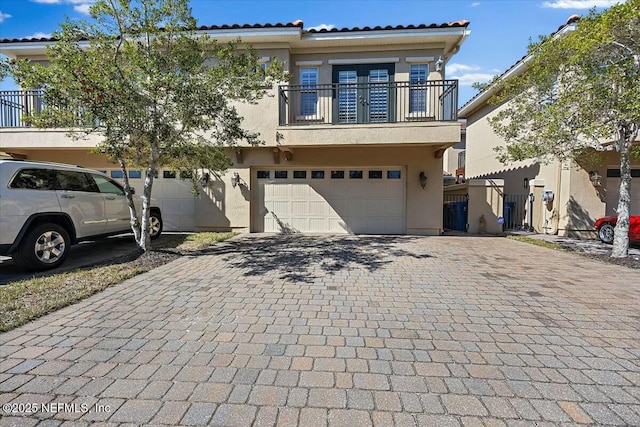 view of front of property with a garage and a balcony