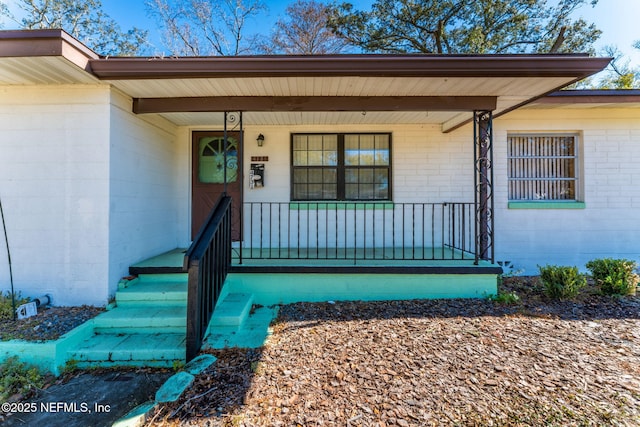 doorway to property featuring a porch