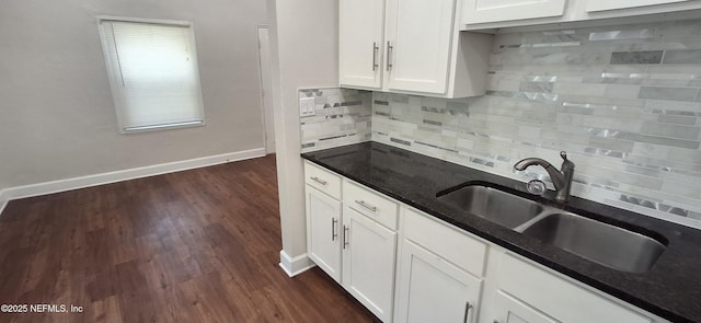 kitchen featuring sink, white cabinets, dark hardwood / wood-style floors, and tasteful backsplash