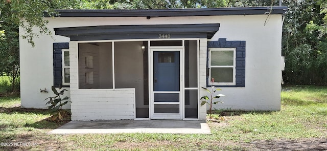 entrance to property with a yard