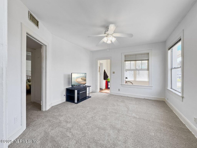 interior space featuring light carpet and ceiling fan