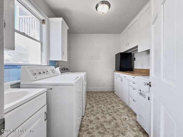 laundry room featuring cabinets and washer and dryer