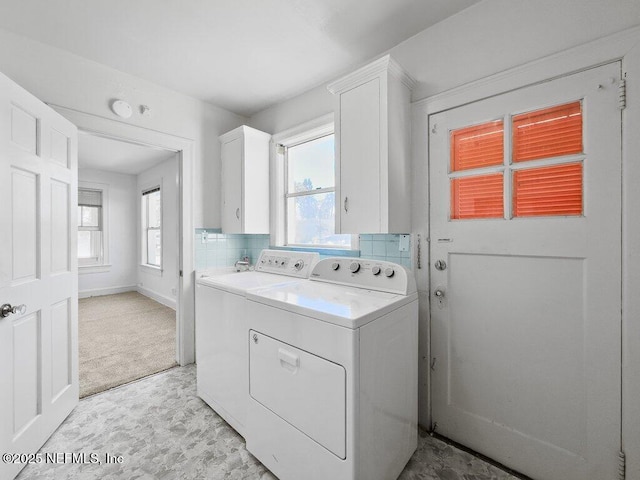 laundry room featuring cabinets and washer and dryer