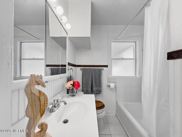 full bathroom with shower / tub combo, sink, tile patterned floors, and toilet