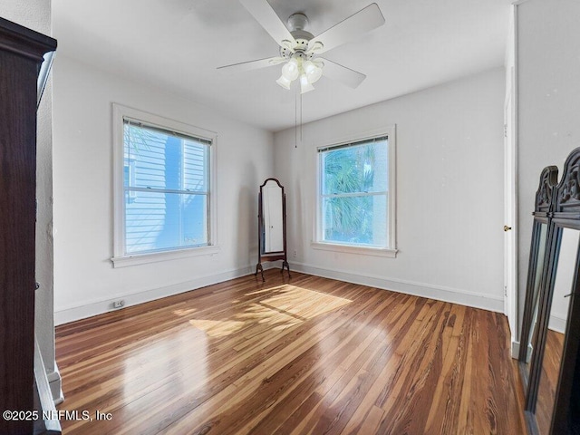 empty room with ceiling fan and wood-type flooring