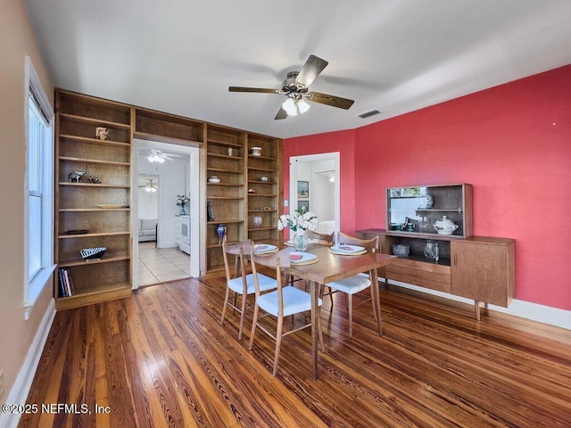 dining room with hardwood / wood-style flooring, ceiling fan, plenty of natural light, and built in shelves