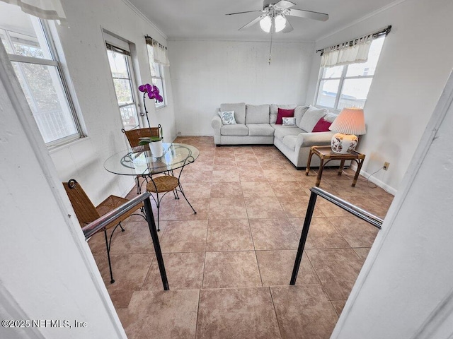 living room featuring light tile patterned flooring, ceiling fan, and crown molding