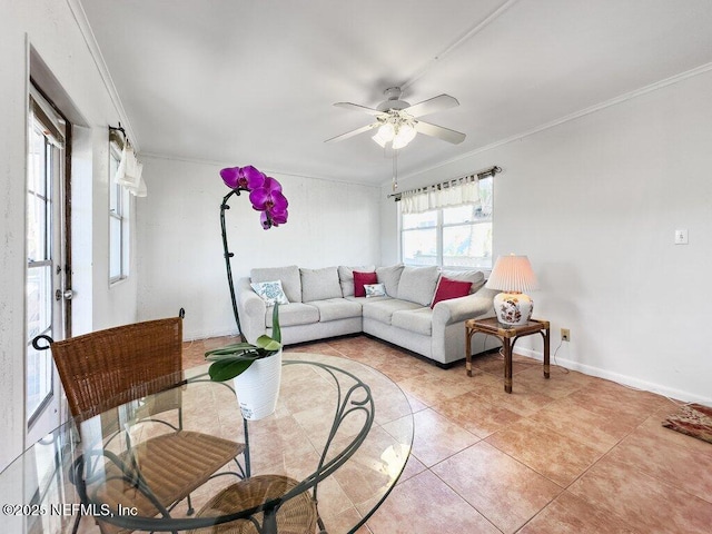 living room with light tile patterned floors, crown molding, and ceiling fan