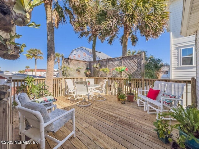 wooden deck featuring outdoor dining area