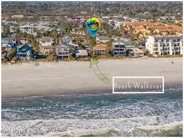 birds eye view of property with a water view, a residential view, and a view of the beach