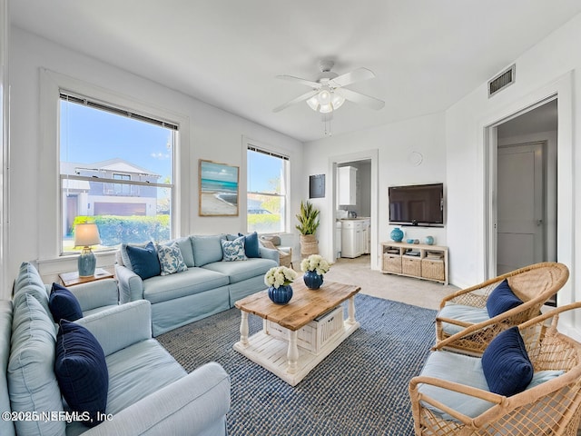 living room featuring carpet floors and ceiling fan