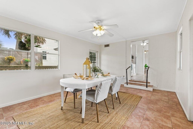 dining space featuring light tile patterned floors, baseboards, visible vents, ceiling fan, and ornamental molding