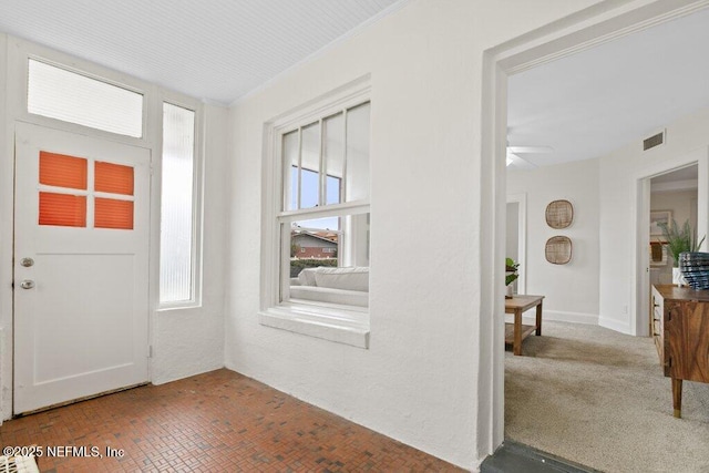 entryway with visible vents and ceiling fan