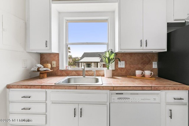 kitchen with a sink, white cabinetry, and dishwasher