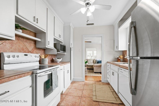 kitchen with white appliances, light tile patterned floors, visible vents, white cabinets, and backsplash