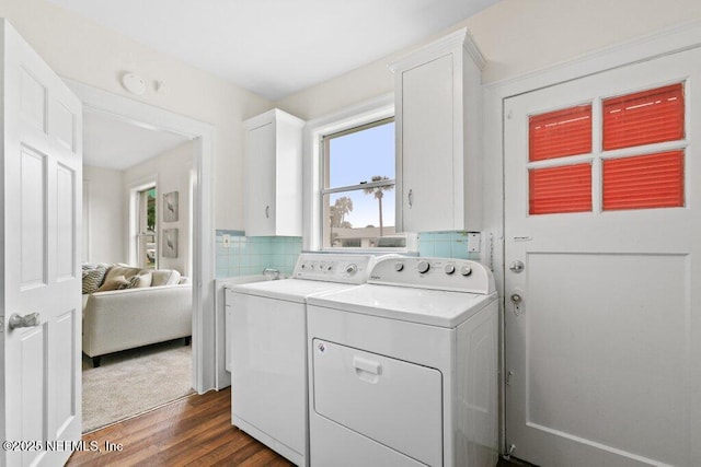 washroom featuring dark wood-style floors, cabinet space, and washer and dryer