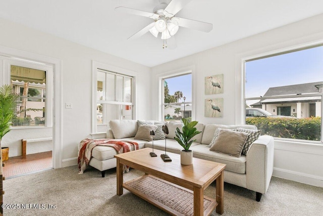 interior space featuring a ceiling fan, a healthy amount of sunlight, and baseboards