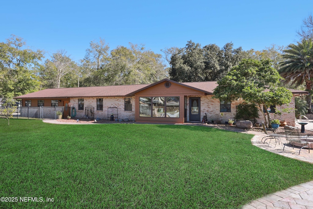 single story home with a patio and a front lawn