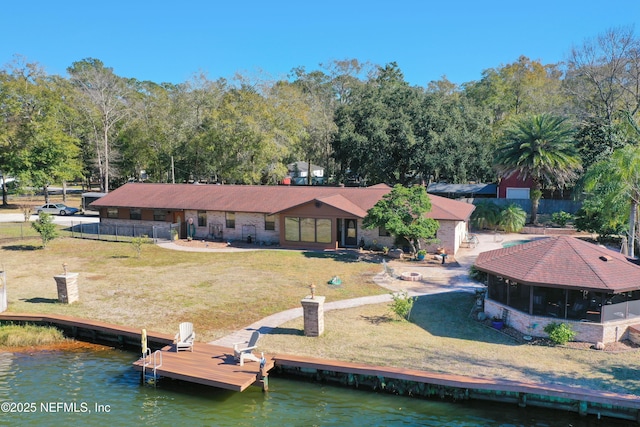 rear view of house with a yard and a water view