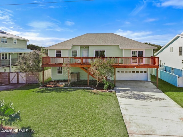 front facade featuring a front lawn, a garage, and a wooden deck