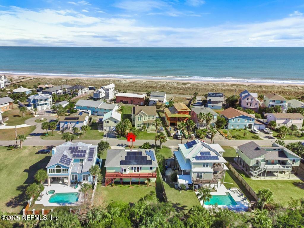 drone / aerial view featuring a beach view and a water view