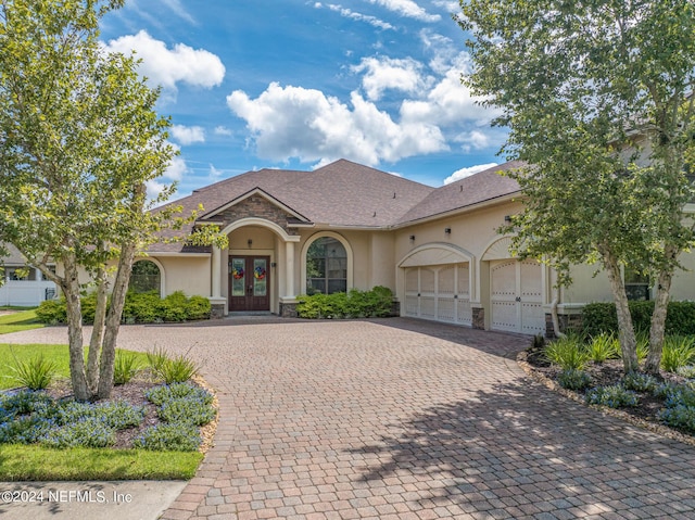 view of front of house with french doors and a garage