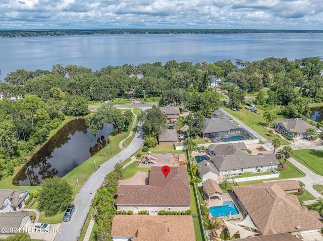 birds eye view of property with a water view