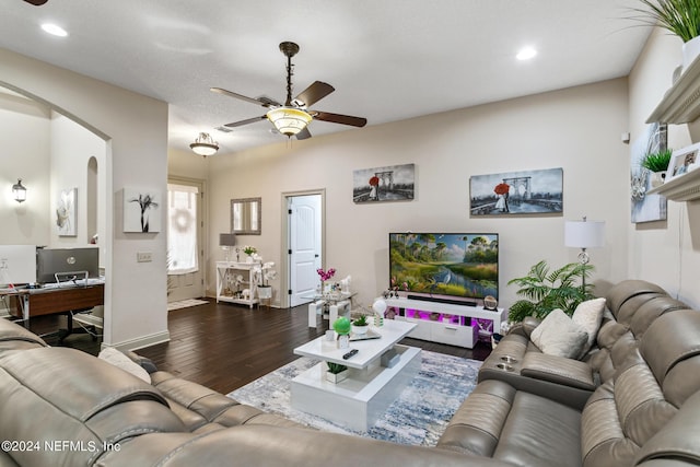 living room featuring dark hardwood / wood-style flooring and ceiling fan