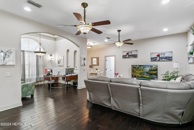 living room with ceiling fan and dark hardwood / wood-style flooring