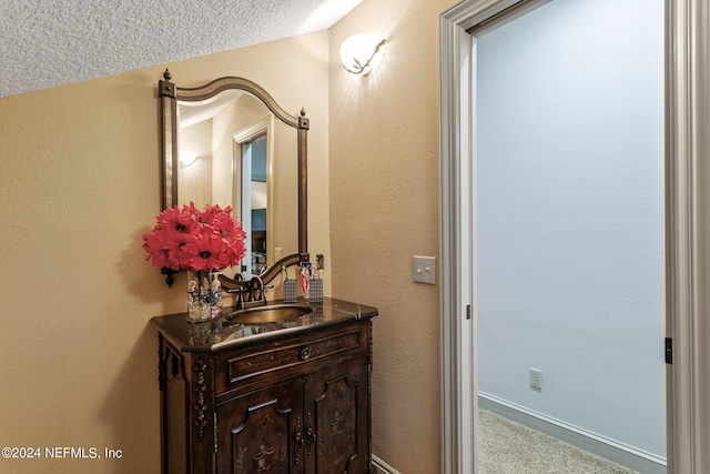 bathroom featuring vanity and a textured ceiling