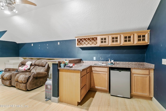 bar featuring sink, dishwasher, lofted ceiling, ceiling fan, and light hardwood / wood-style floors