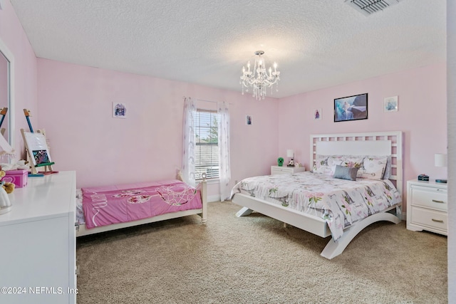 bedroom featuring a textured ceiling, a notable chandelier, and carpet floors