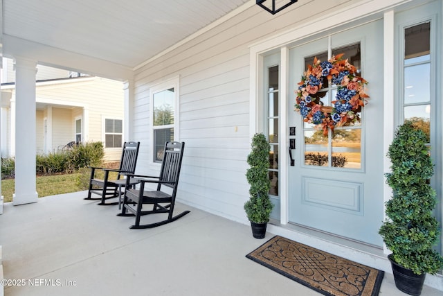 view of exterior entry featuring a porch