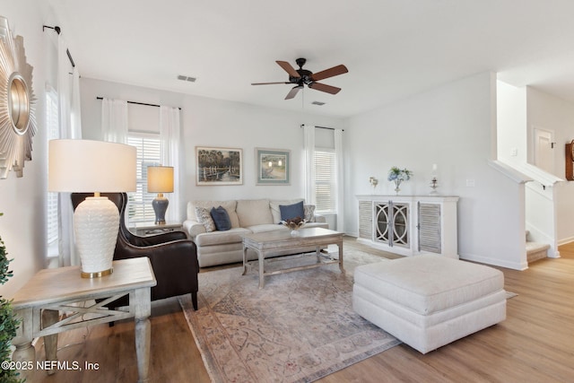 living room with ceiling fan and hardwood / wood-style floors