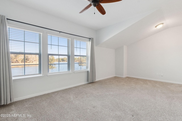 interior space featuring lofted ceiling, ceiling fan, and carpet