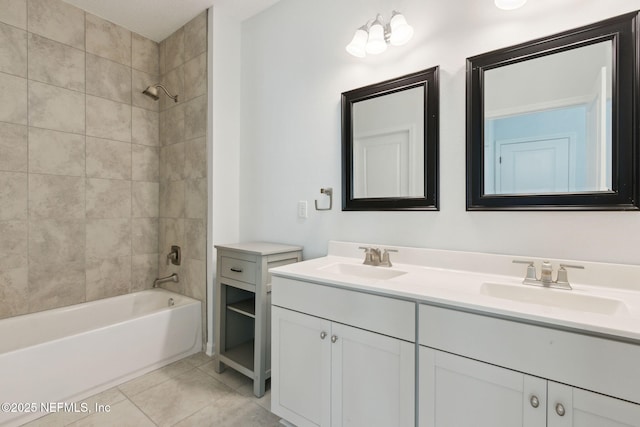 bathroom featuring tiled shower / bath combo, tile patterned floors, and vanity